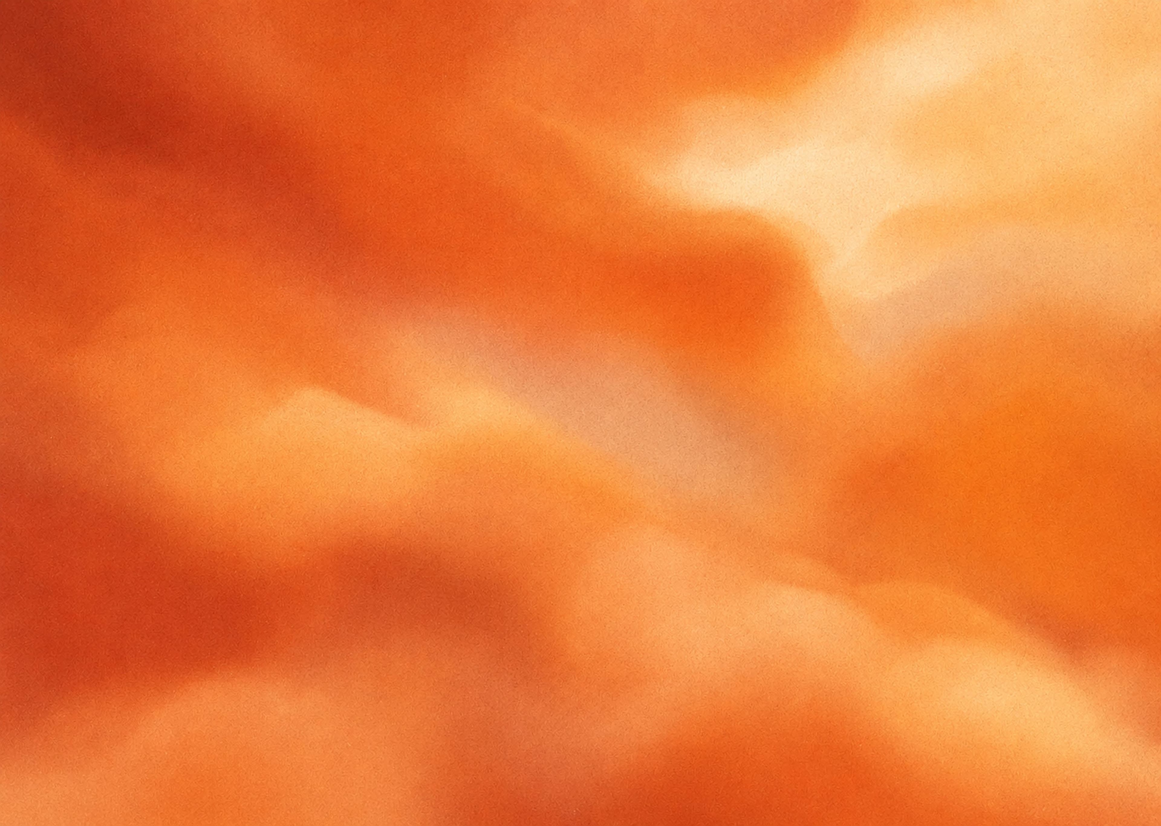 Warm orange clouds blurred into soft waves